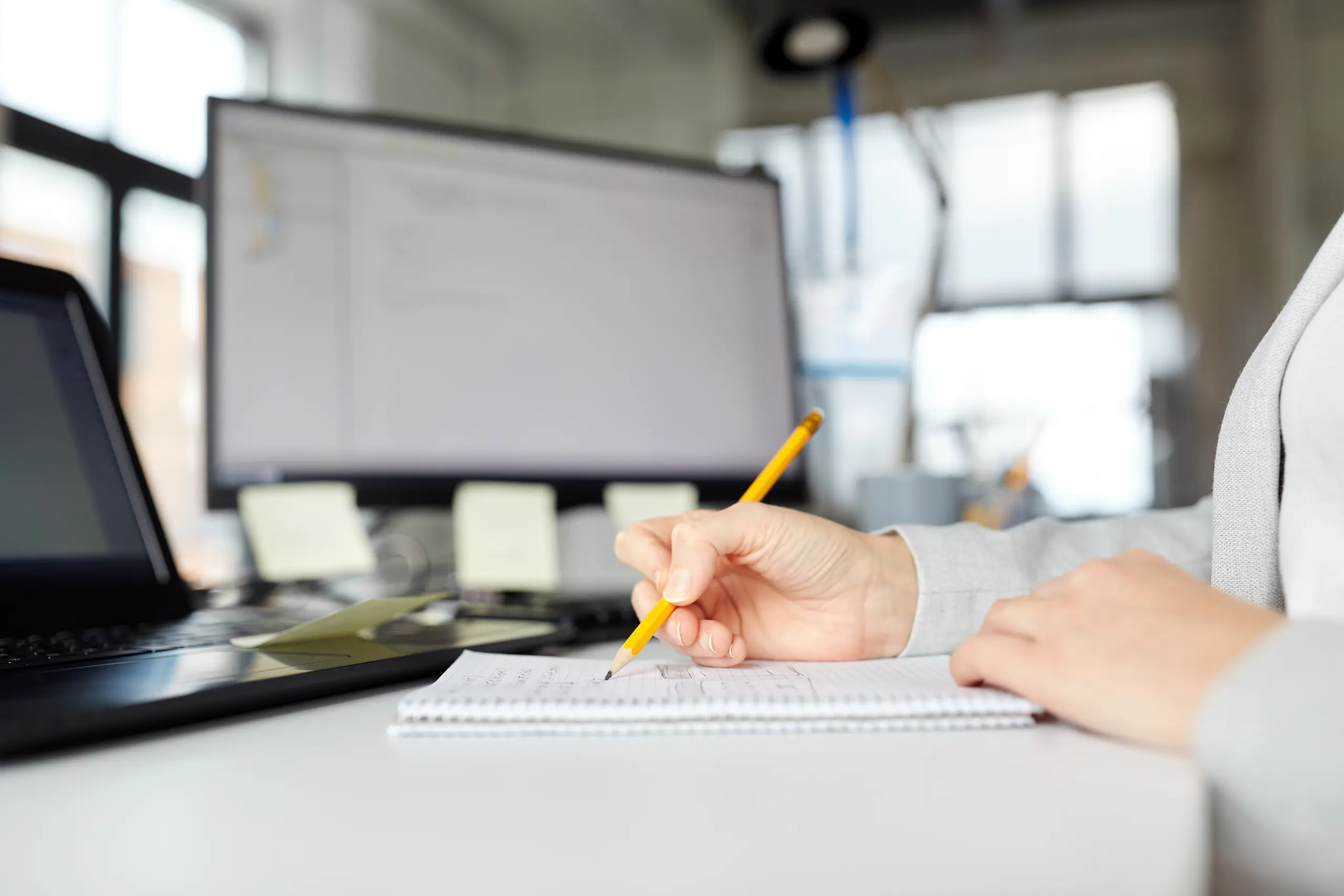 Businesswoman with notebook and laptop in an office