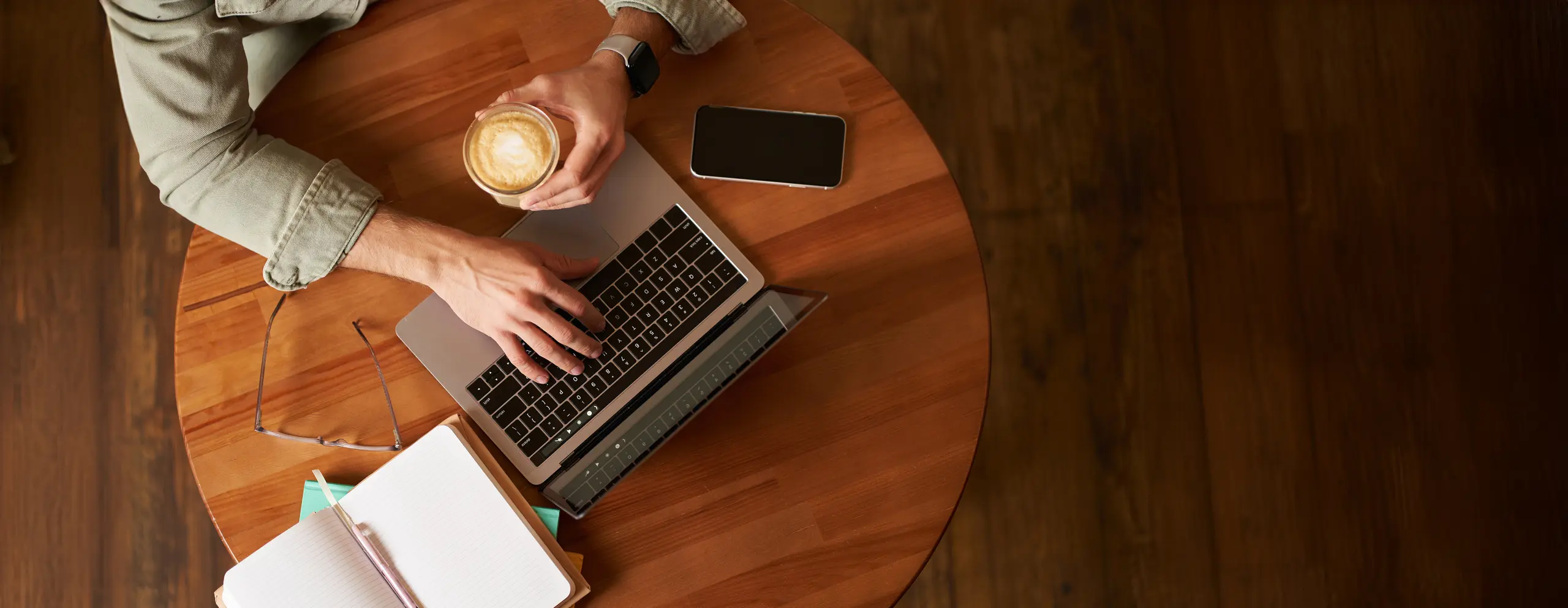 Top view of male at a coworking space with e-learning setup