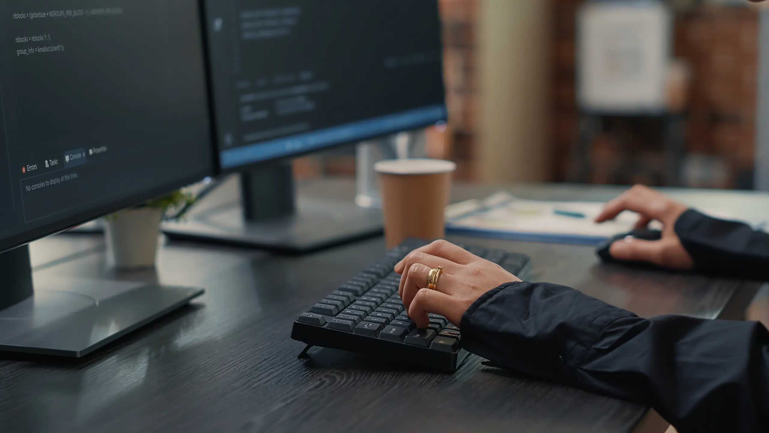 Developer typing code on a laptop, close-up
