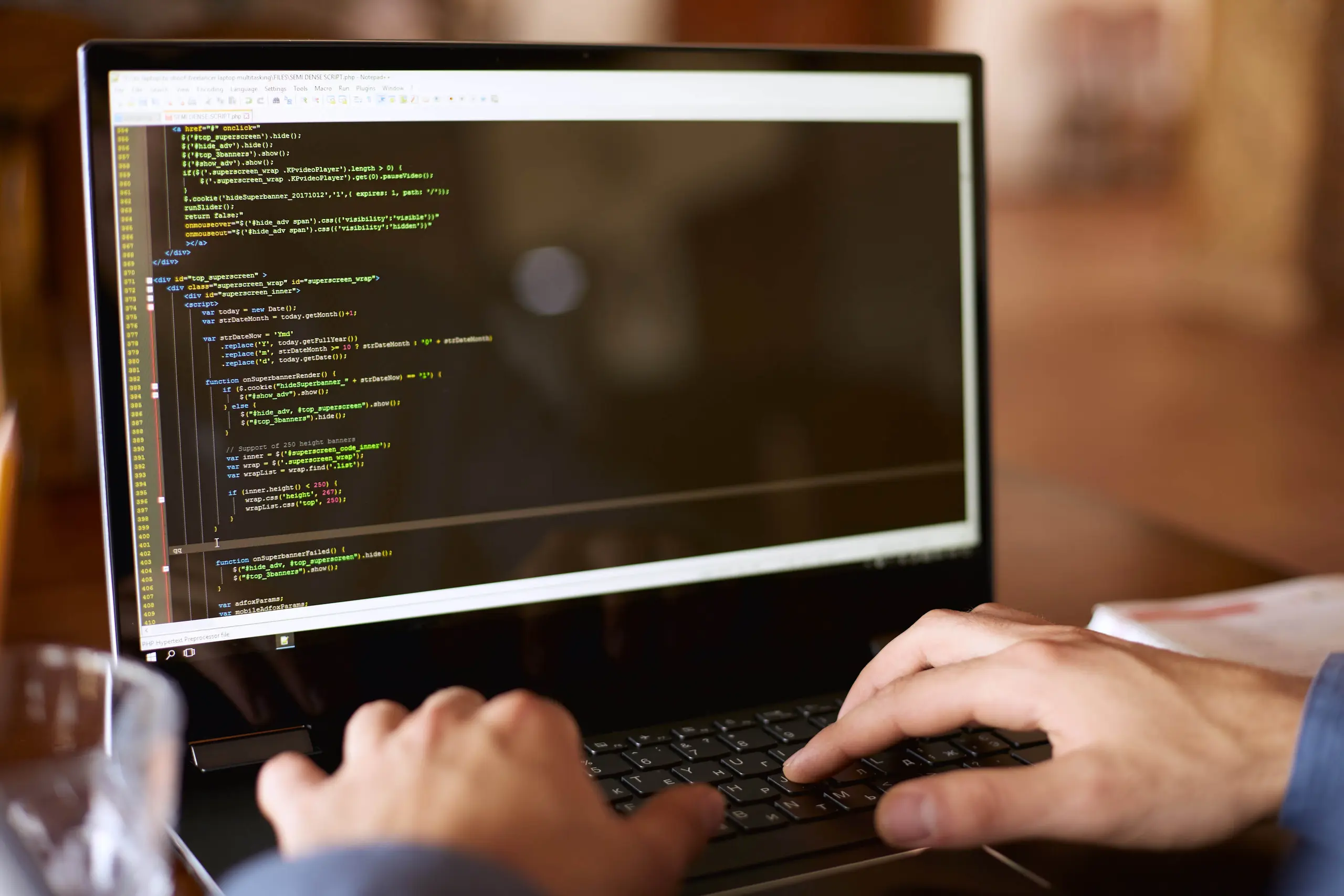 Developer typing code on a laptop