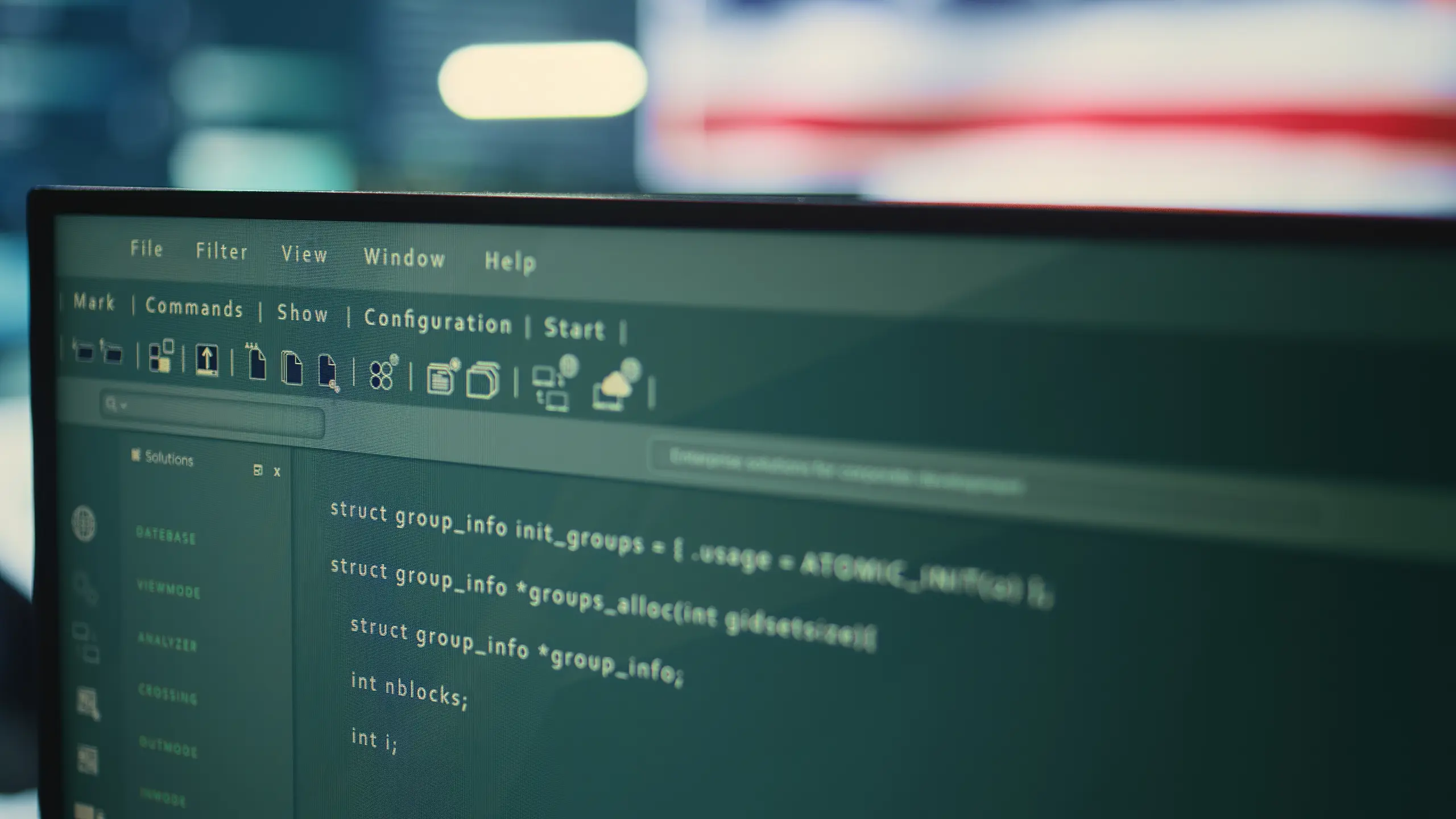 Close-up of code on an upper left monitor in a server room