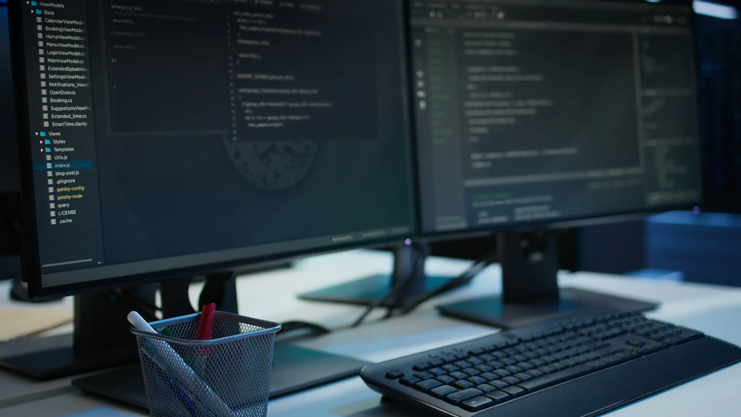 Close-up angled right view of dual monitors with code in a data center