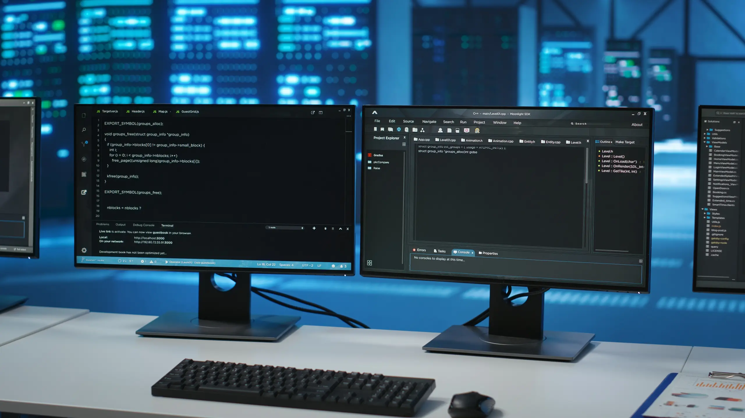 Dual monitors showing code and data, front view in a data center
