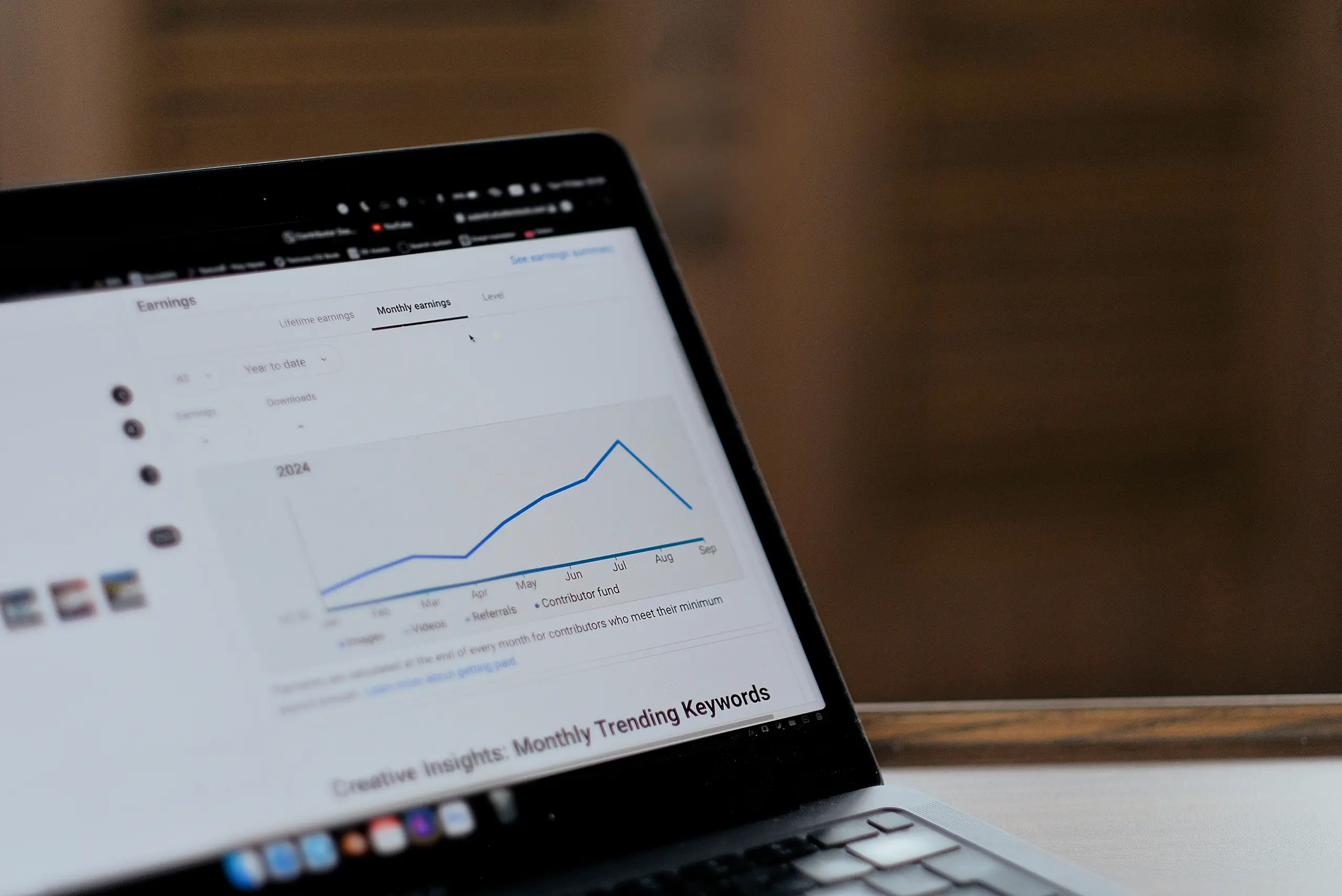 Close-up of a laptop showing a monthly trending graph