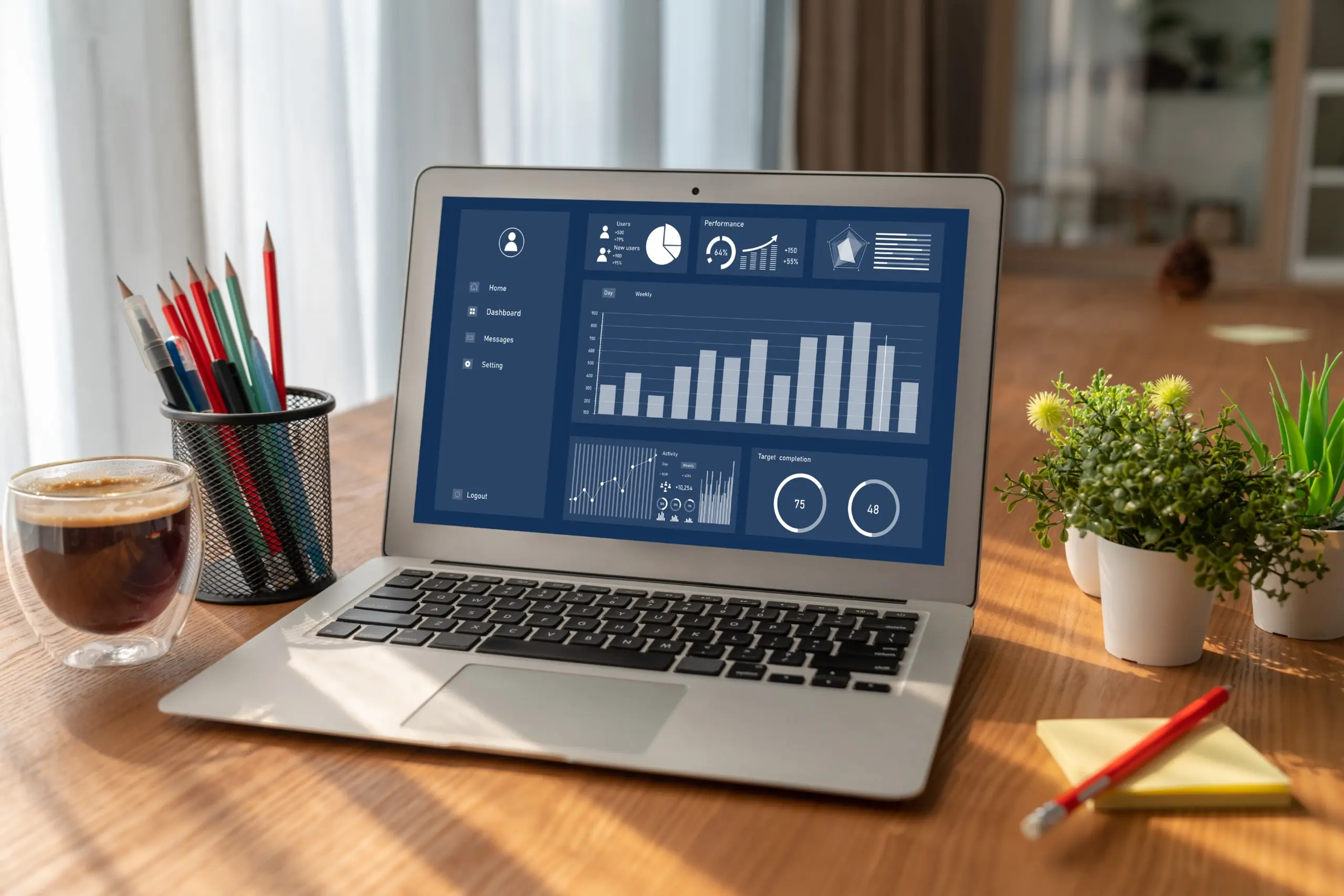 Laptop with data dashboard, dark background, angled left view