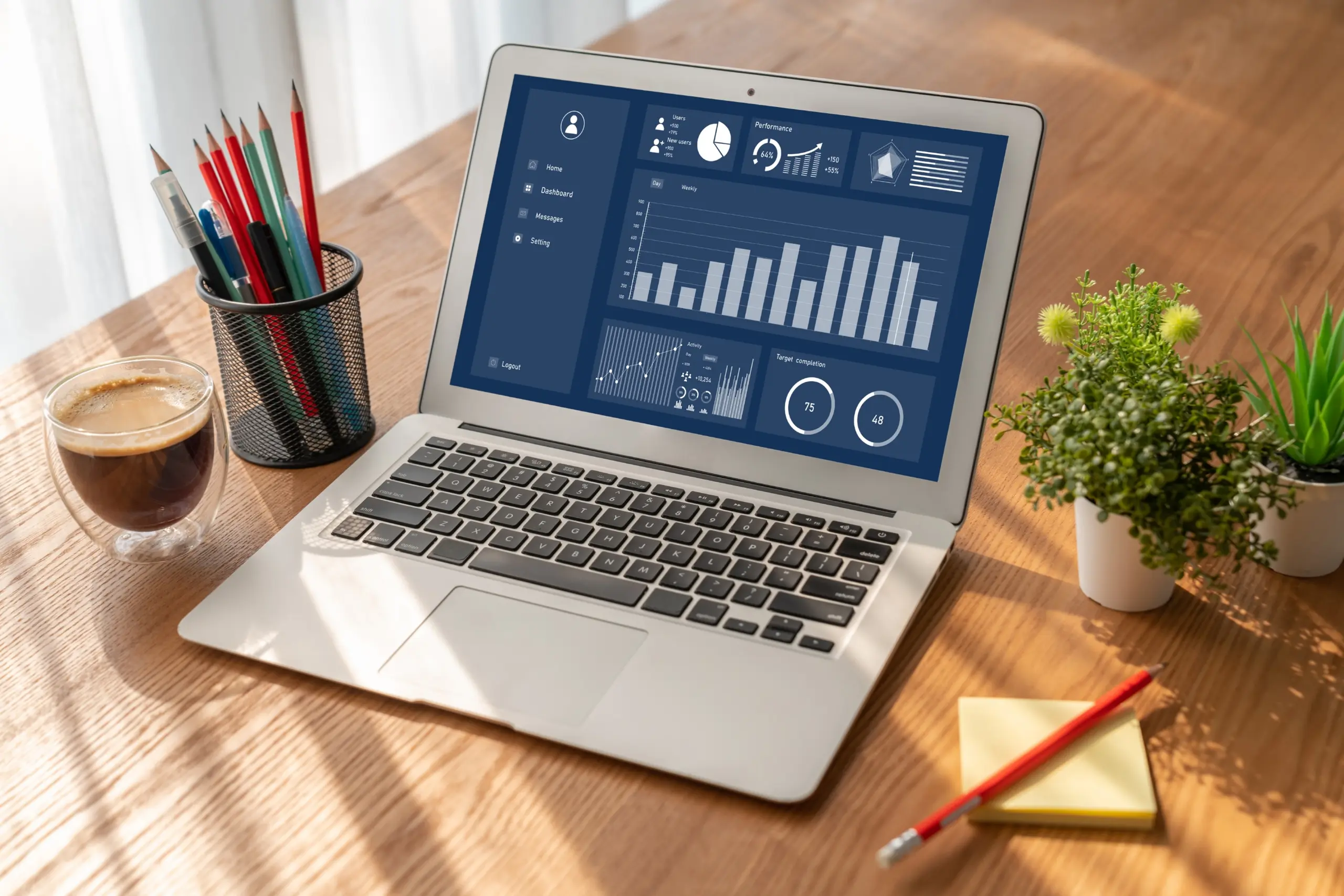 Laptop with data dashboard, dark background, top-left angle