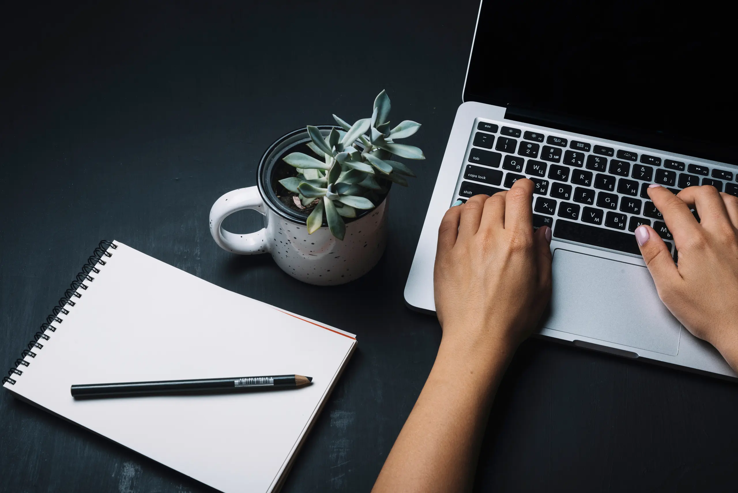 Notepad and laptop on a desk