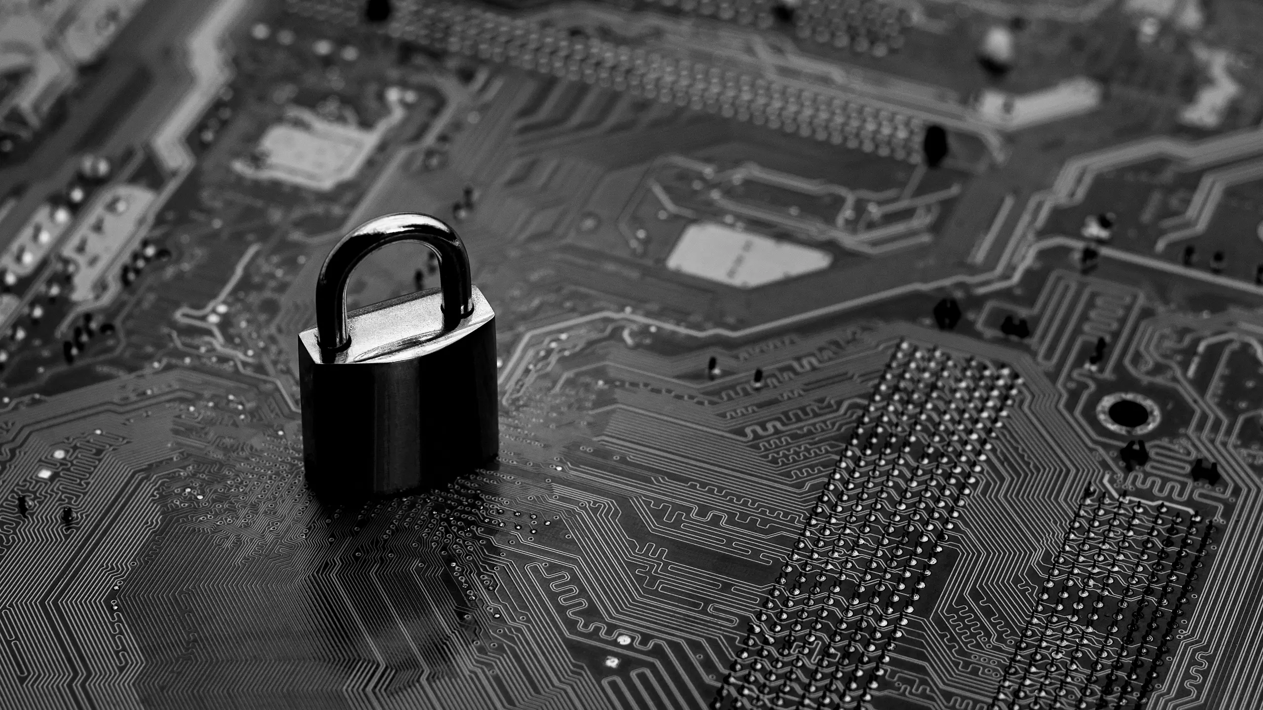 Padlock standing upright on a gray motherboard