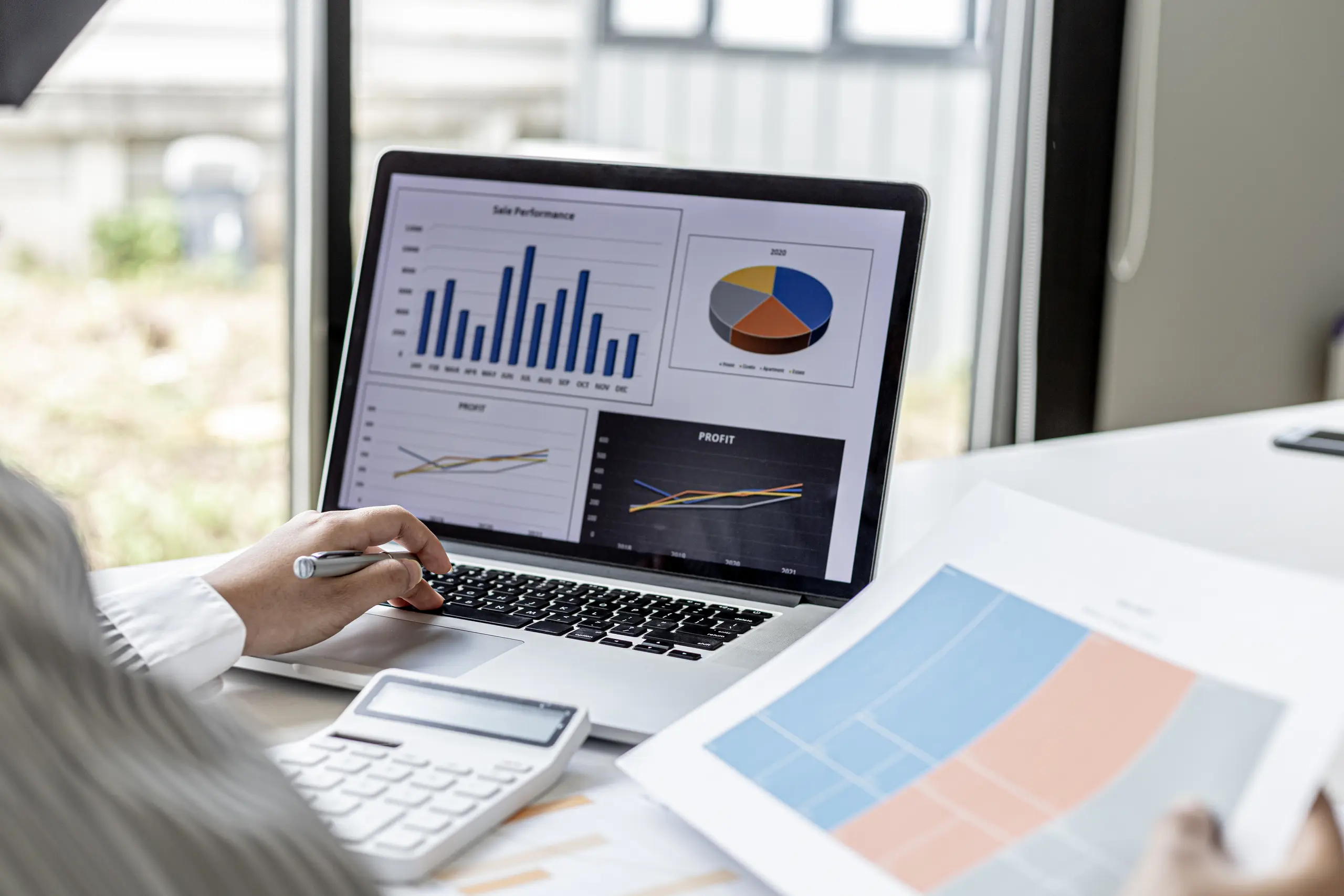 Person viewing a data dashboard and data sheet