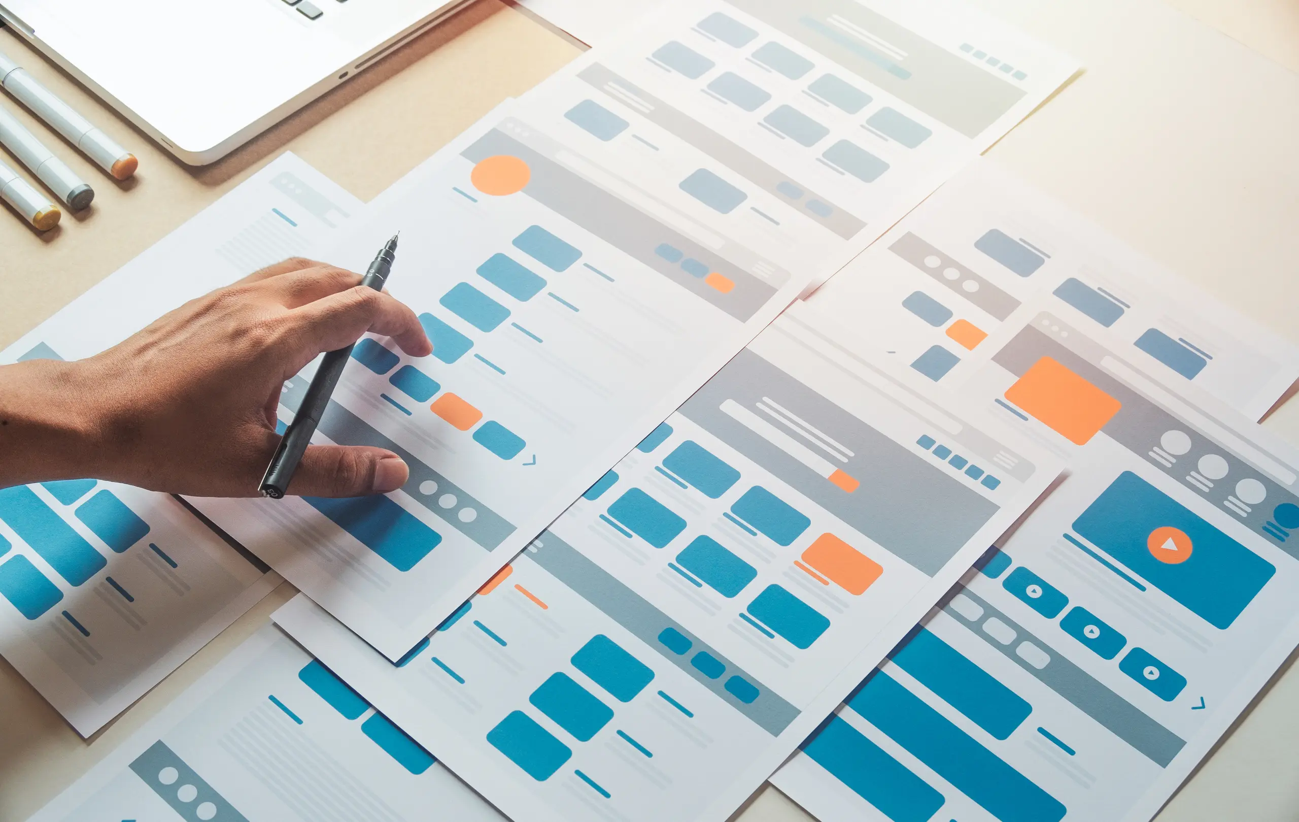 Person working on UI/UX design sheets